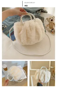 Detail of cream white plush handbag featuring woven leather handles and soft fuzzy texture