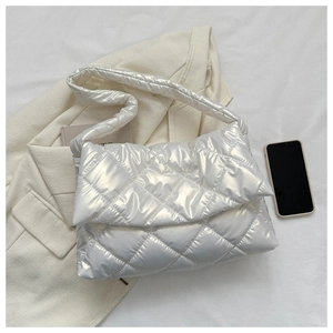 Detail of silver quilted cloud bag showing metallic texture with stylish blazer