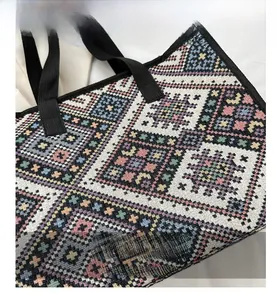 Close-up of ethnic woven tote bag featuring colorful geometric patterns and durable straps