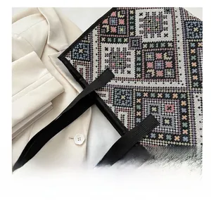 Close-up of geometric knit patterns on a large ethnic tote bag with black woven handles