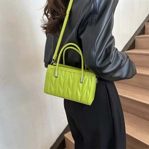 Neon green pleated crossbody bag with quilted V-texture and silver hardware