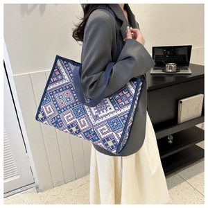 Detailed close-up of ethnic woven pattern on high-capacity tote bag for women
