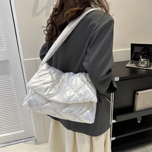 Quilted silver puffer shoulder bag with metallic finish and large diamond stitch pattern