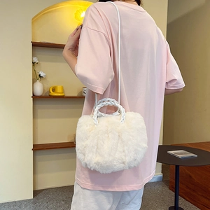White faux fur cloud bag with woven handle shown from behind on a model in minimalist room