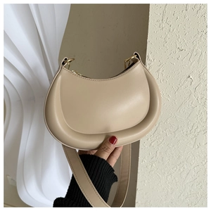 Detail of apricot crescent bag with matte leather finish and golden metal zipper hardware