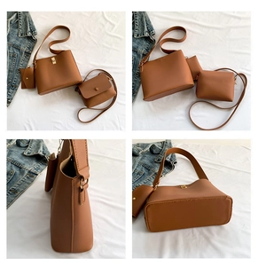 Detail view of brown PU leather bag set with gold hardware and wide shoulder strap