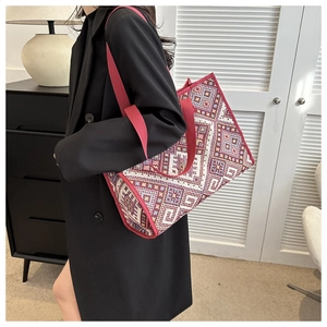 Detailed close-up of ethnic canvas tote bag with vibrant geometric woven patterns