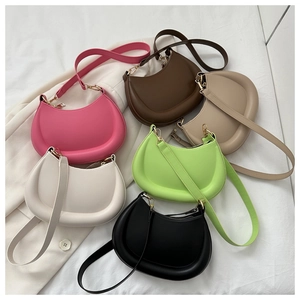 Flat lay of trendy crescent hobo bags in six colors with gold hardware and shoulder straps