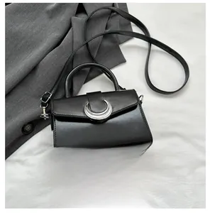 Detail of vintage black square bag with silver crescent buckle and size reference