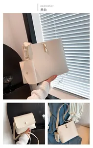 Detailed view of off-white leather shoulder bag set with gold buckle and mini pouch