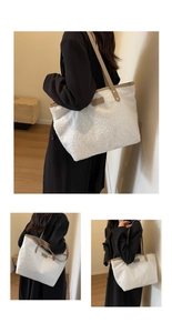Detail view of large white plush tote bag with FASHION leather tag and PU handles