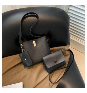 Detailed close-up of a 3-piece black leather bag set featuring golden metal twist locks