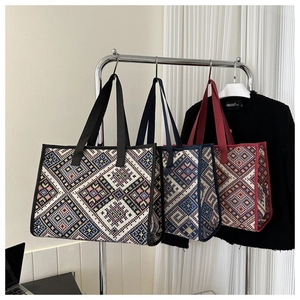 Detail of ethnic geometric woven canvas tote bags with colorful diamond patterns