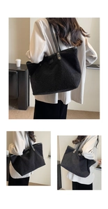 Detail of large black plush tote bag with durable leather straps and gold rivets