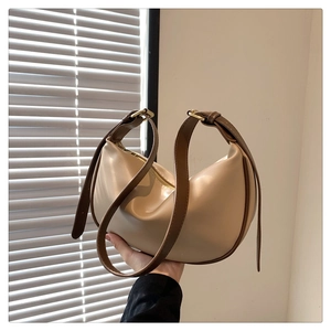 Detail showing contrast straps and beige leather of a soft vintage hobo shoulder bag