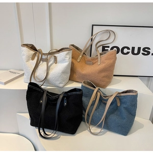Close-up of four colors of fuzzy teddy tote bags with leather handles and rivets