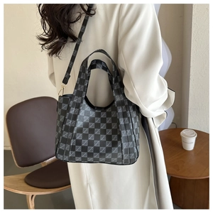 Detail showing checkered patterns and adjustable strap of this vintage bucket bag