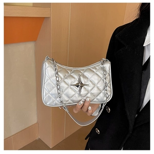 Detailed view of silver quilted crossbody bag with metal star logo and chain strap