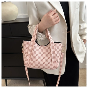 Detail of pink and white checkered bucket bag with letter Z pattern and top handles