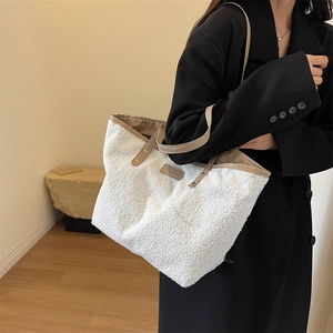 White teddy fleece tote bag with brown leather handles and fashion patch detail