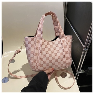 Detail shot of pink plaid tote bag with geometric pattern and adjustable strap