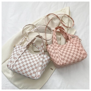 Detail of white and pink plaid tote bags with metallic hooks and detachable shoulder straps