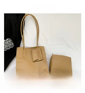 Detailed view of camel faux leather tote bag set with pebble texture and matching pouches
