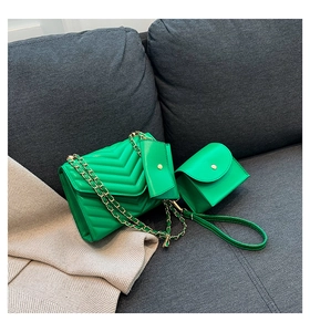 Detail of lime green quilted 3-piece bag set with gold chain on a cozy fabric surface
