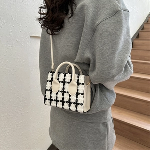 Fashionable black and white tweed checkered crossbody bag with adjustable shoulder strap