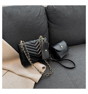 Detailed view of black quilted PU leather 3-piece bag set with gold chain and hardware