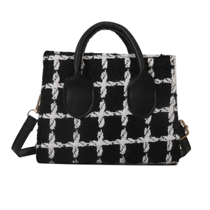 Classic black and white checkered tweed handbag with gold hardware and faux leather straps