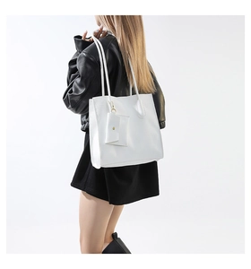 Close-up of white lychee pattern tote bag with matching coin purse on a model