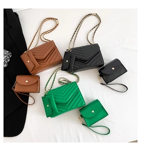 Detailed view of chevron quilted faux leather texture with elegant golden metal chain strap