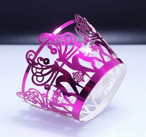 Laser-cut deer and snowflake cupcake wrappers in metallic magenta for party desserts