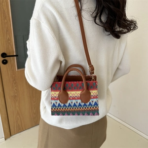 Bohemian colorful woven crossbody bag with brown handles and a stylish striped pattern