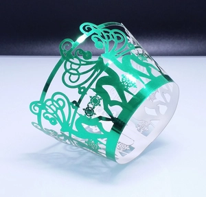Metallic green laser-cut cupcake wrappers with reindeer and forest镂空 design