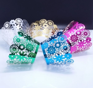 Detail of laser-cut lace cupcake liners in five metallic colors for wedding party decoration