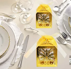 Close-up of golden laser-cut snowflake gift box with white chiffon ribbon bow