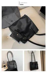 Detail of black pebbled leather tote bag with matching pouch and gold chain accents