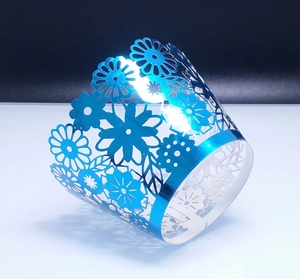 Royal blue laser-cut floral cupcake wrappers with metallic finish and daisy patterns