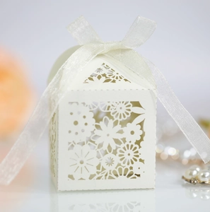 Détails du motif floral ajouré au laser sur une boîte cadeau de couleur blanc crème