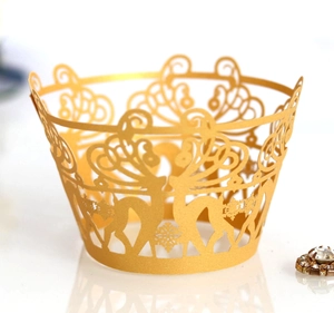 Detailed laser-cut gold cupcake wrapper with festive reindeer and snowflake patterns
