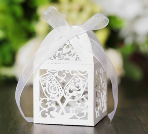 Laser-cut white wedding favor box with wine glass design and white organza ribbon bow