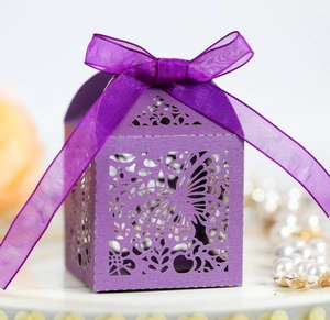 Detailed laser-cut purple gift box featuring floral patterns and a matching silk ribbon