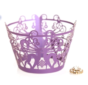 Close-up of laser-cut lavender cupcake wrapper with deer and snowflake patterns