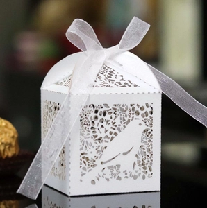 White laser cut wedding favor box with bird and floral patterns and organza ribbon
