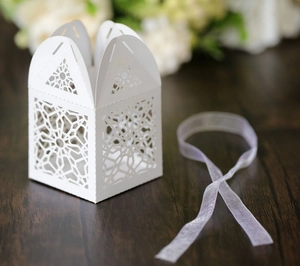 Macro shot of white laser-cut star patterns on an elegant wedding gift paper box