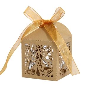 Detailed laser-cut butterfly patterns on brown kraft paper gift box with gold ribbon