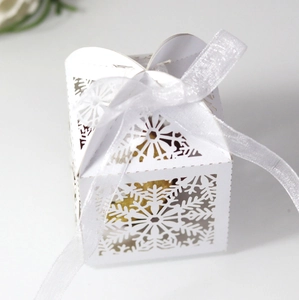 Detailed close-up of a white snowflake hollow candy box with an elegant organza ribbon tie