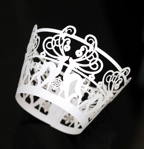 Detail of laser-cut cupcake wrappers featuring reindeer and snowflake patterns